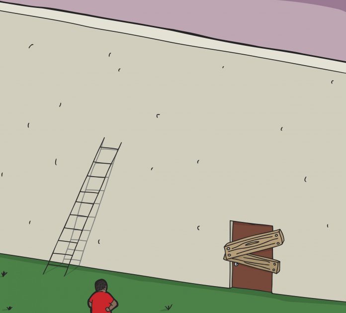 Man facing short ladder and blocked door at wall