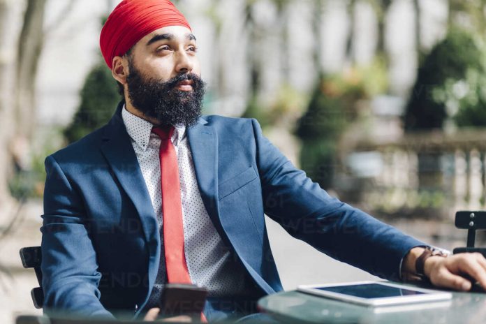 indian-businessman-sitting-in-manhattan-using-smartphone-GIOF01518