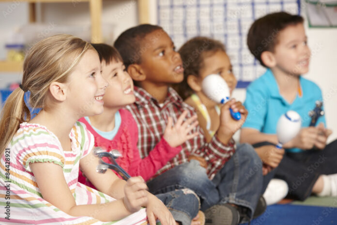group-of-elementary-age-schoolchildren-in-music-class-with-instruments-stockpack-adobe-stock