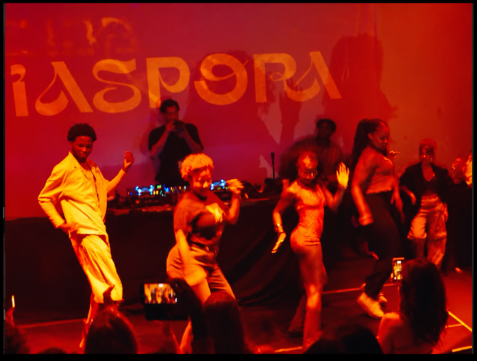 Dancers under red stage lights